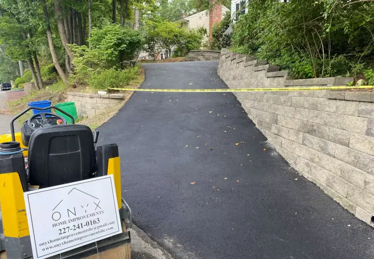 Freshly laid asphalt driveway curing in the sun