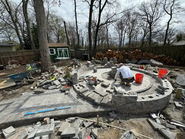 Backyard patio stone fireplace under construction