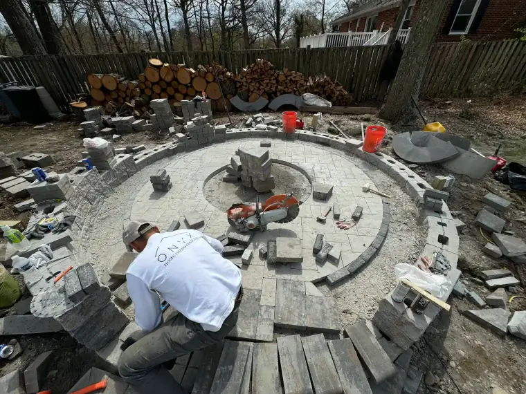 Mason performing a fireplace and patio installation