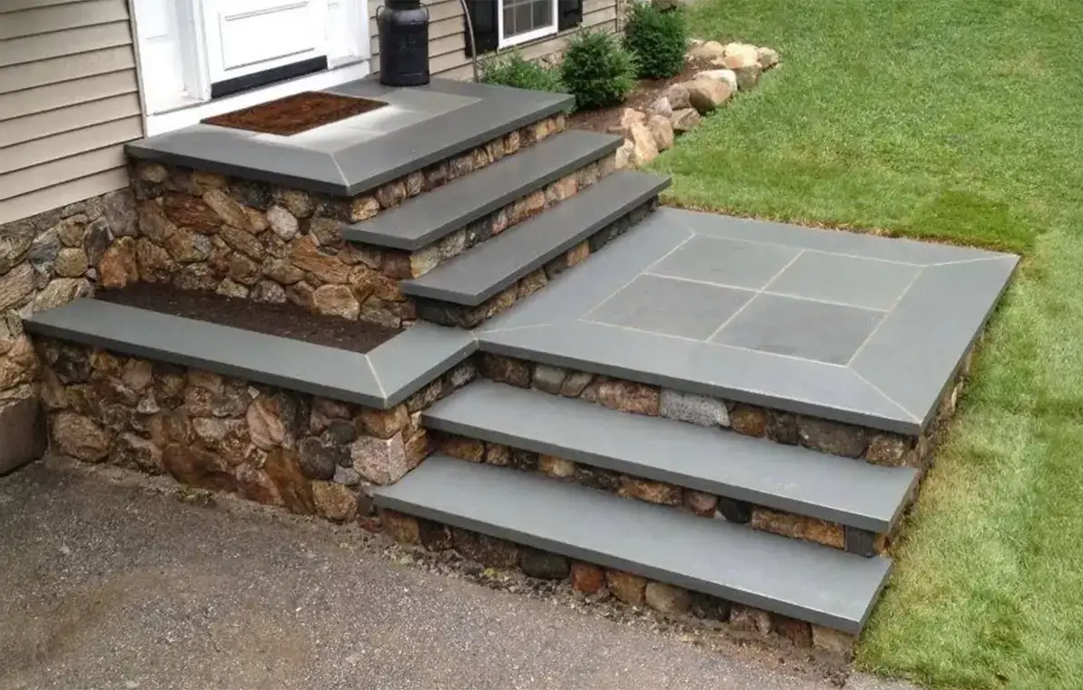 Natural stone steps rising to a home entrance