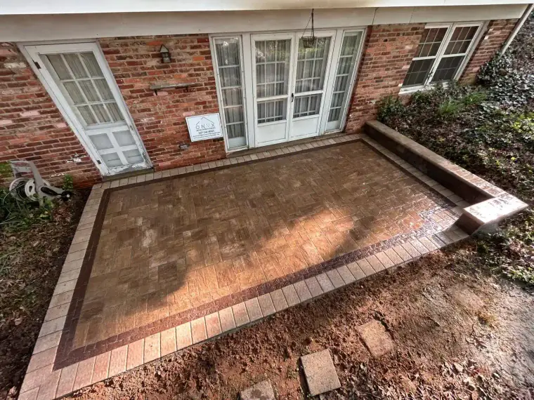 Freshly installed brick and natural stone backyard patio