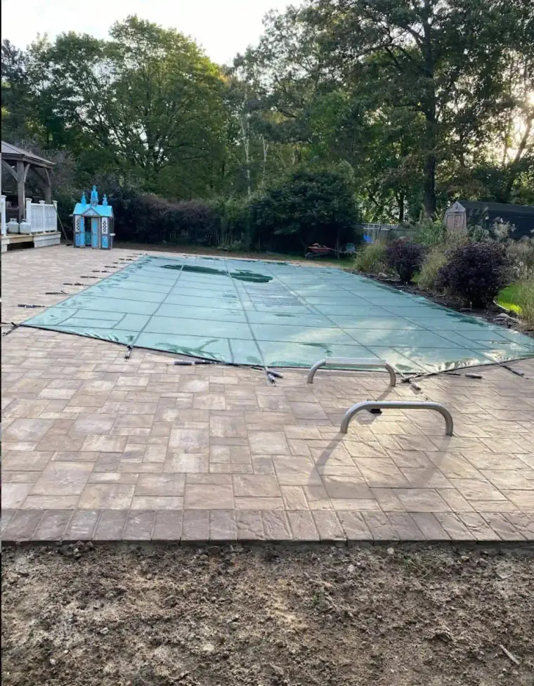 Natural stone pool deck in a backyard