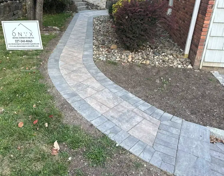 Natural stone walkway running along the side of a house