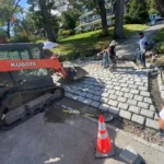Onyx Home Improvement LLC contractors laying down a new stone walkway.
