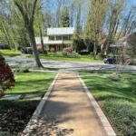 Stone veneer walkway in front of a residential home.