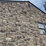 Stone siding of a two-story home.