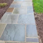 Residential outdoor walkway made of natural stone veneer.