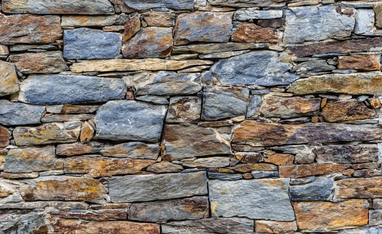 Close-up texture of slate slabs used in natural stone veneer applications.