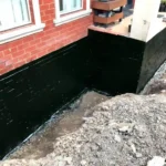 Foundation repair outside of a residential home.