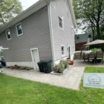 Freshly installed residential foundation surrounding a two story home.