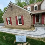 Newly installed stone walkway that curves in and around the front of the home.