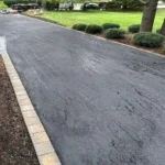 Newly paved residential asphalt driveway.