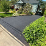 Newly paved residential asphalt driveway.