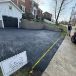 Newly paved residential asphalt driveway.
