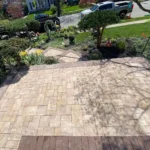 Stone patio in front of a residential home.