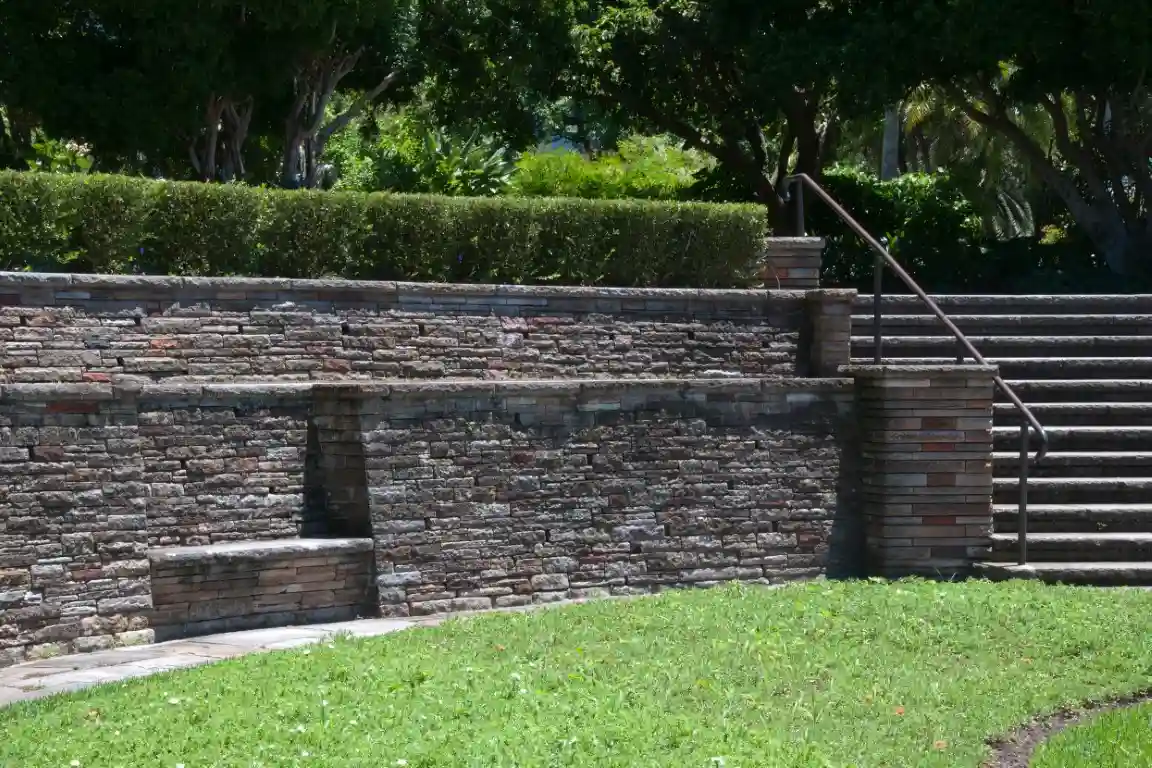 Dry stone seat wall in garden with staircase.