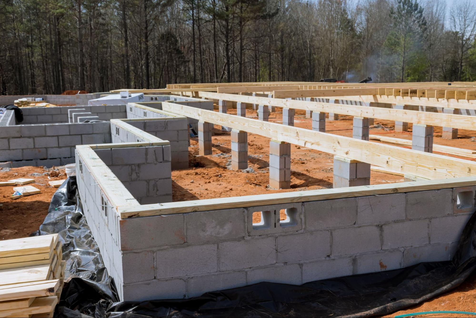 Cement blocks forming a concrete foundation wall at a house construction site.