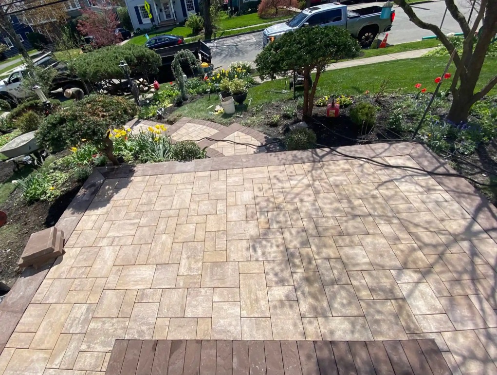 Landing patio with travertine tiles leading to outdoor stairs.