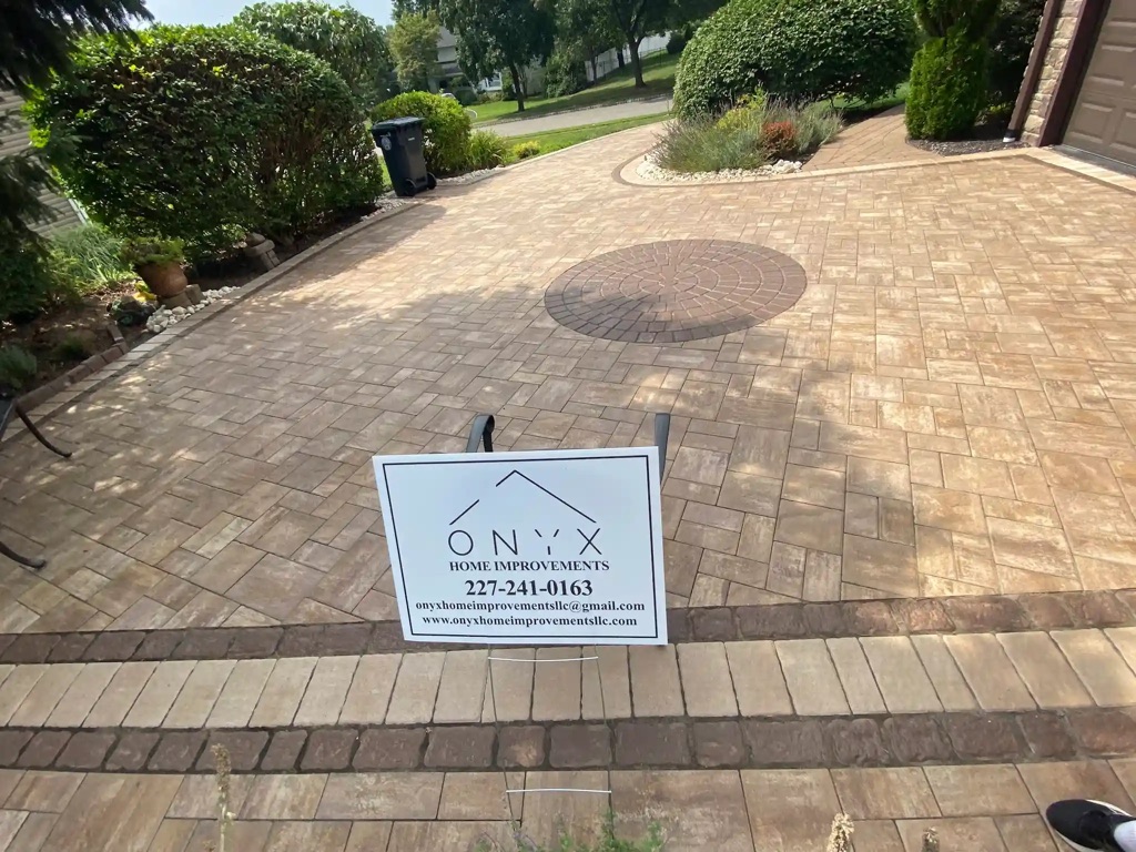Patio with interlocking brown and beige geometric pavers.
