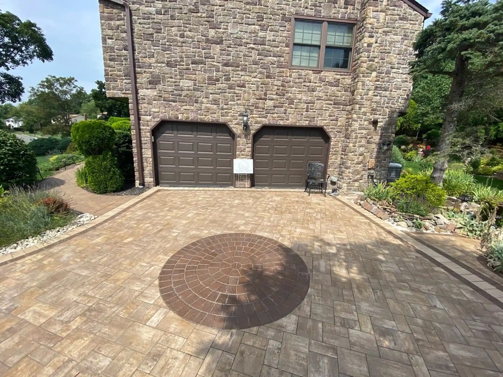 Detailed view of textured stone bricks on a house exterior, with natural patterning and adjacent walkway.