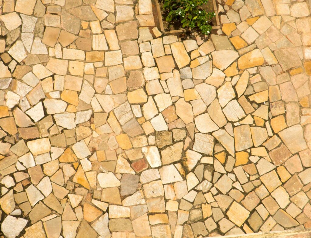 Overhead view of a warm-toned stone patio.
