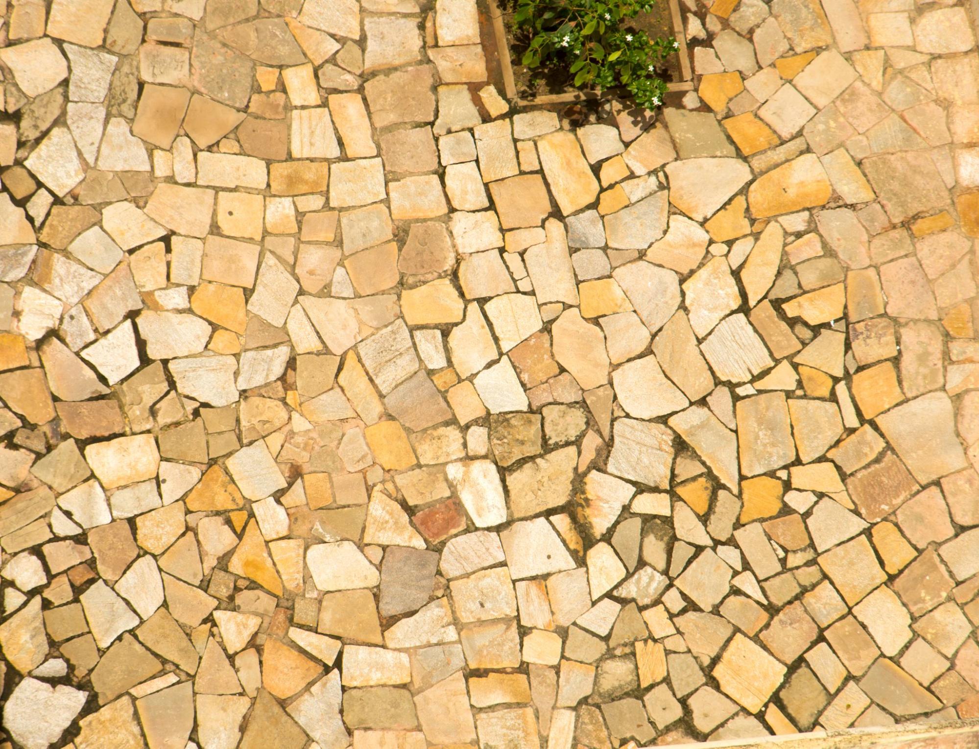 Overhead view of a warm-toned stone patio.