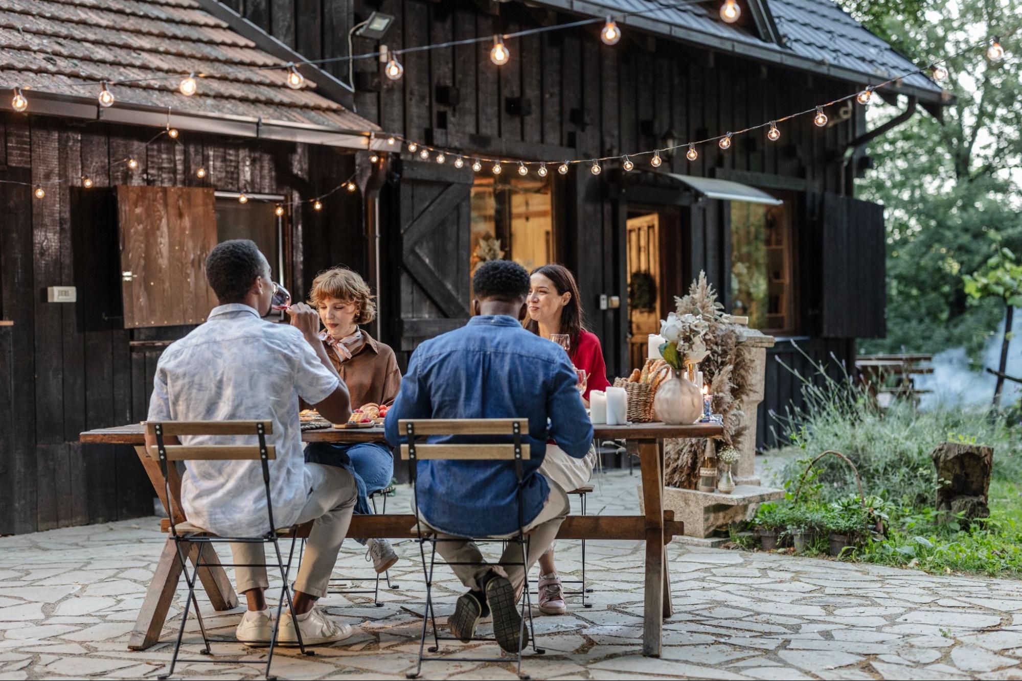Outdoor dinner gathering at a cozy countryside home patio