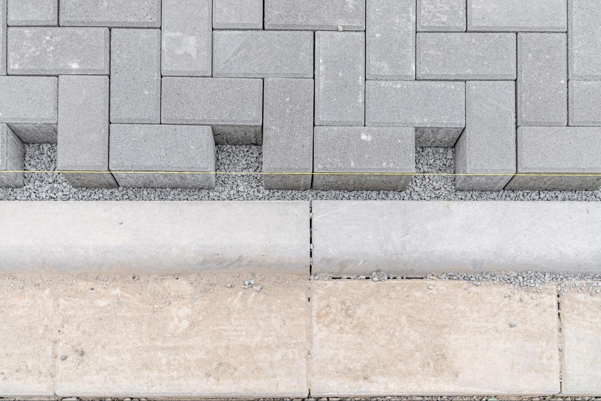 Paver stones and a concrete driveway border.